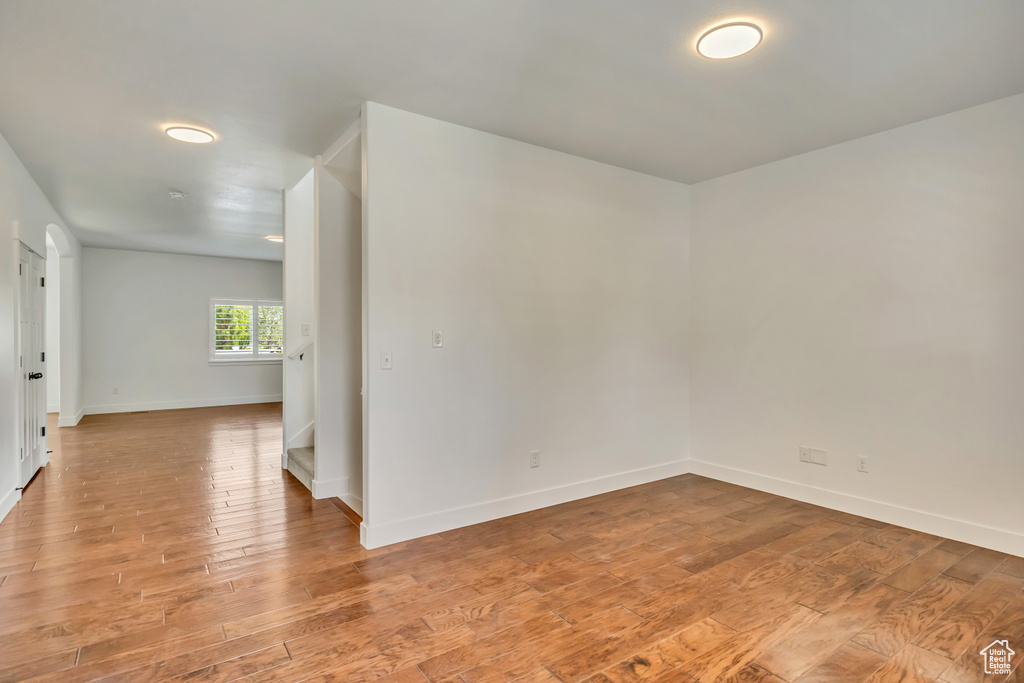 Unfurnished room featuring light wood-style floors and baseboards