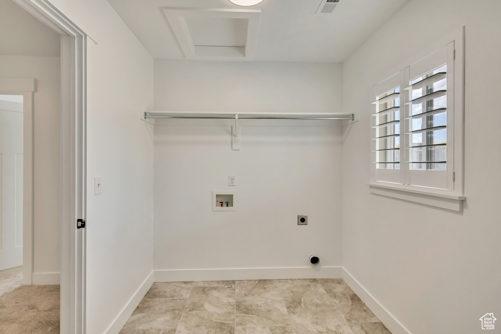 Washroom featuring hookup for an electric dryer, washer hookup, attic access, and baseboards