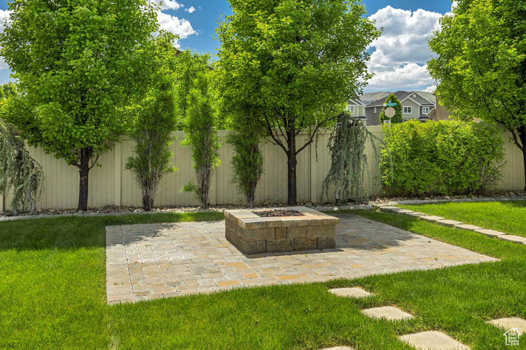View of yard with a fire pit and a patio area