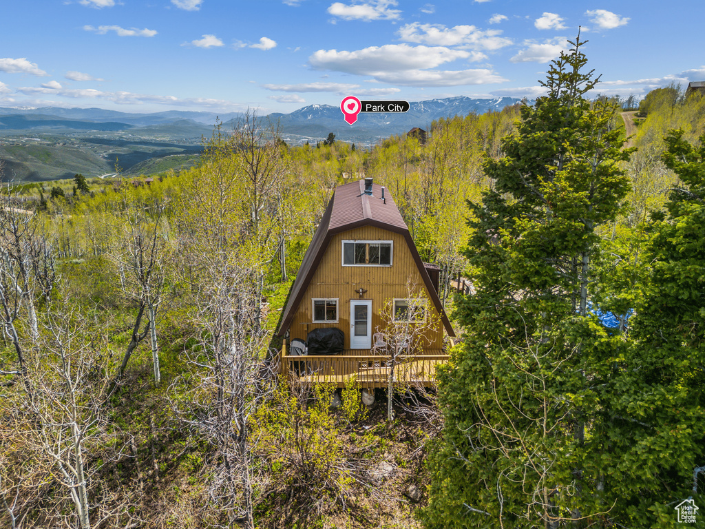 View of front of property featuring a deck with mountain view