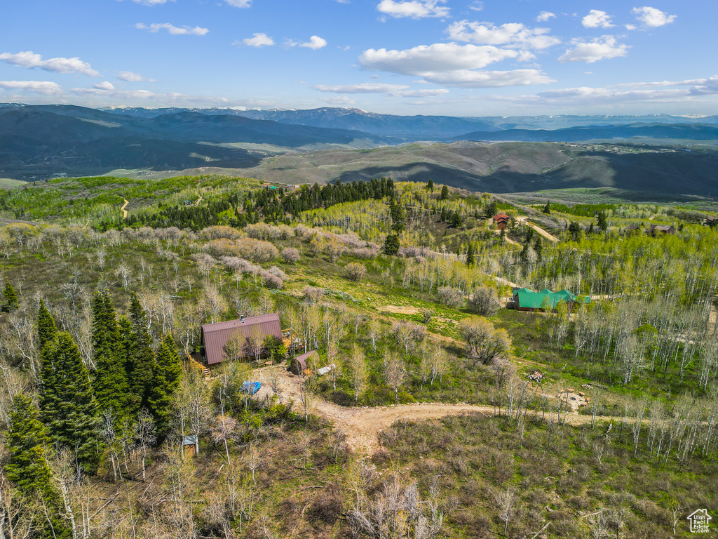 Aerial view of property and surrounding area featuring mountains