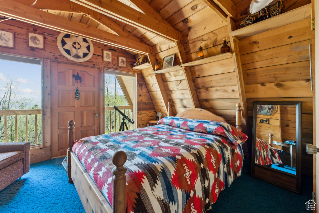 Bedroom featuring carpet flooring, multiple windows, wooden ceiling, and wooden walls