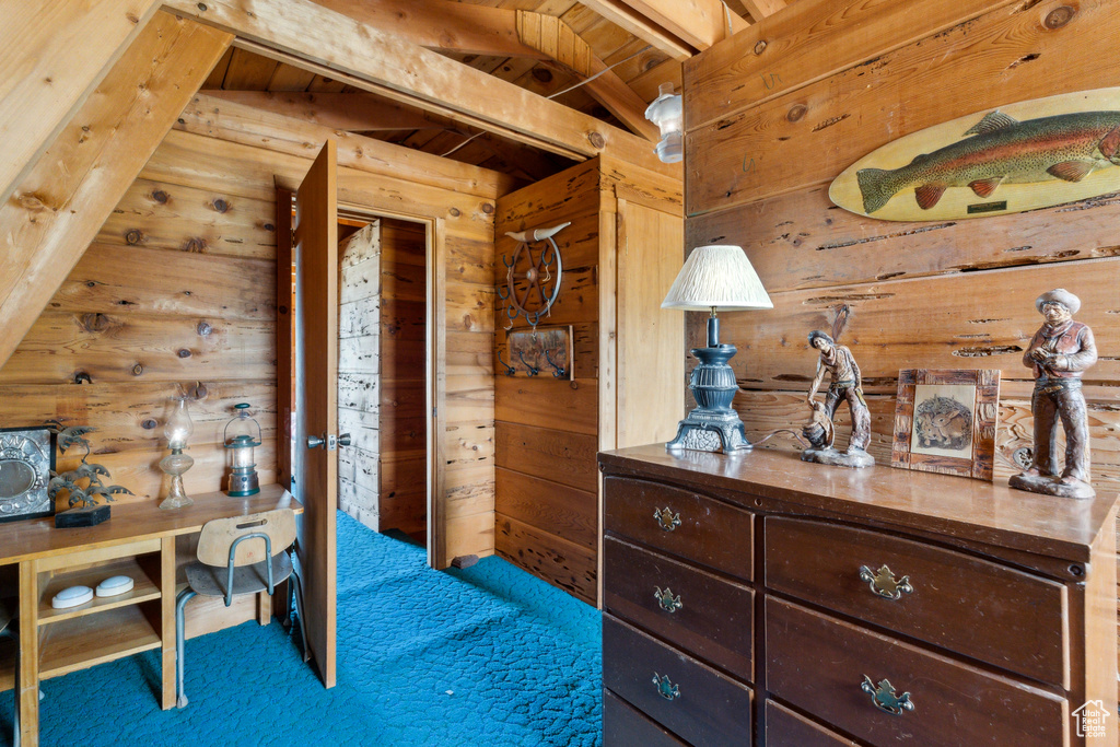 Carpeted bedroom with wood walls