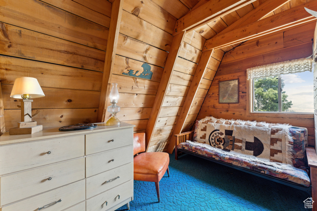 Bedroom with wooden walls and vaulted ceiling