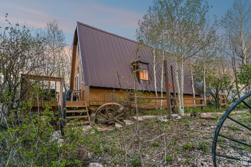 View of home\\\'s exterior with metal roof and a gambrel roof