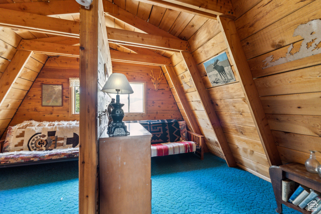 Hall featuring wooden walls, carpet floors, and wood ceiling
