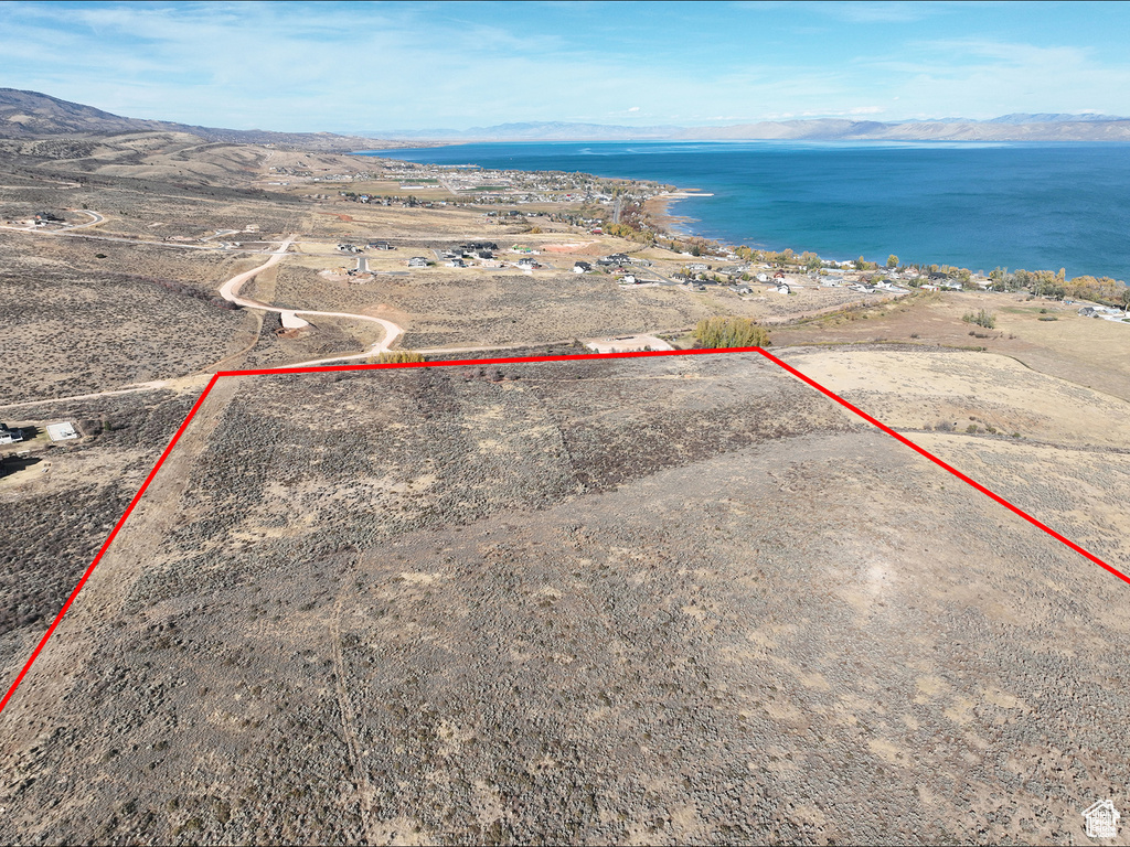 Aerial view of property's location featuring a water and mountain view and property parcel outlined