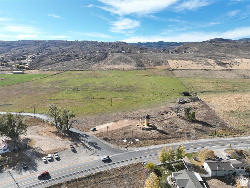 Aerial overview of property's location with rural landscape and a mountain backdrop