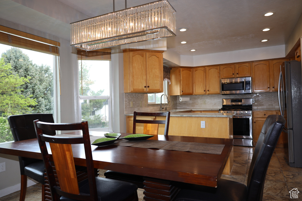 Dining area with recessed lighting and a chandelier
