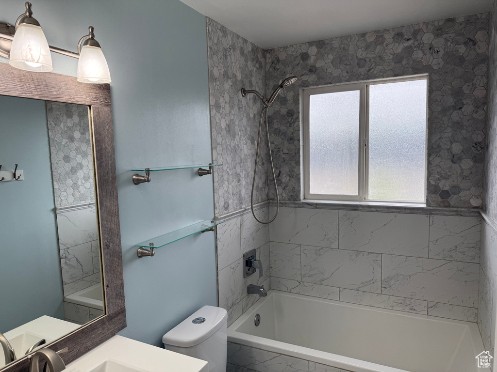 Full bath with toilet, bathtub / shower combination, and vanity