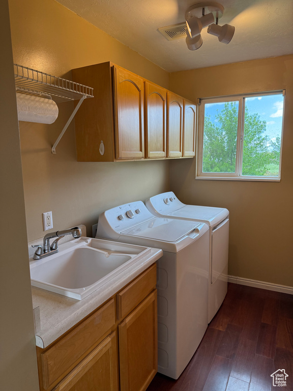 Laundry room featuring cabinet space, independent washer and dryer, dark wood finished floors, and baseboards