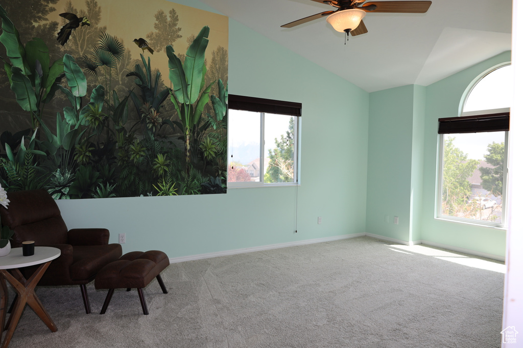 Unfurnished room with vaulted ceiling, carpet, a ceiling fan, and baseboards