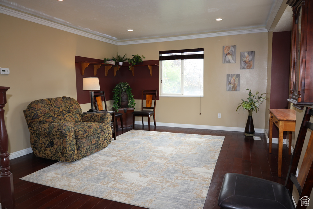 Living room featuring hardwood / wood-style flooring, baseboards, crown molding, and recessed lighting