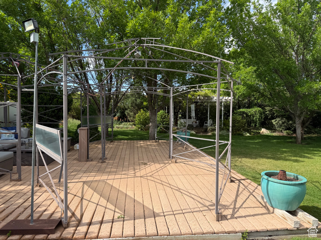 Deck featuring a yard and view of scattered trees