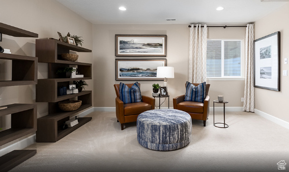 Living area featuring carpet floors, baseboards, and recessed lighting