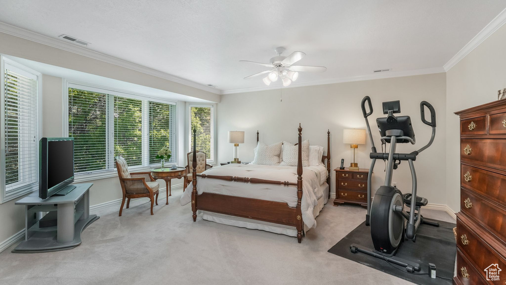 Bedroom featuring light carpet, crown molding, baseboards, and ceiling fan