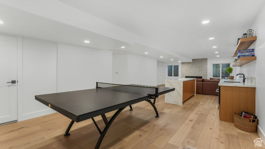 Game room featuring recessed lighting, light wood-style flooring, and a sink