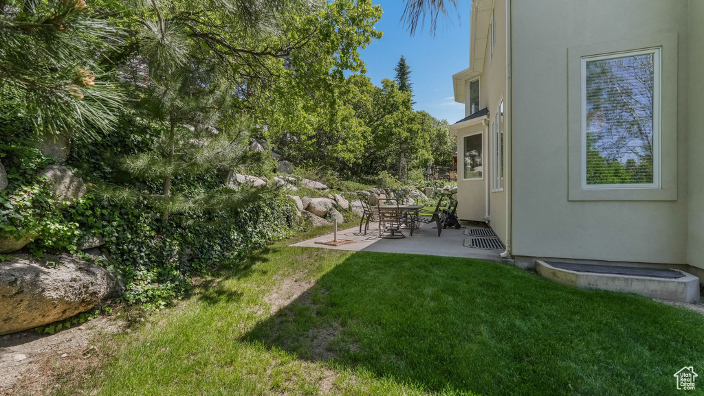 View of grassy yard with a patio