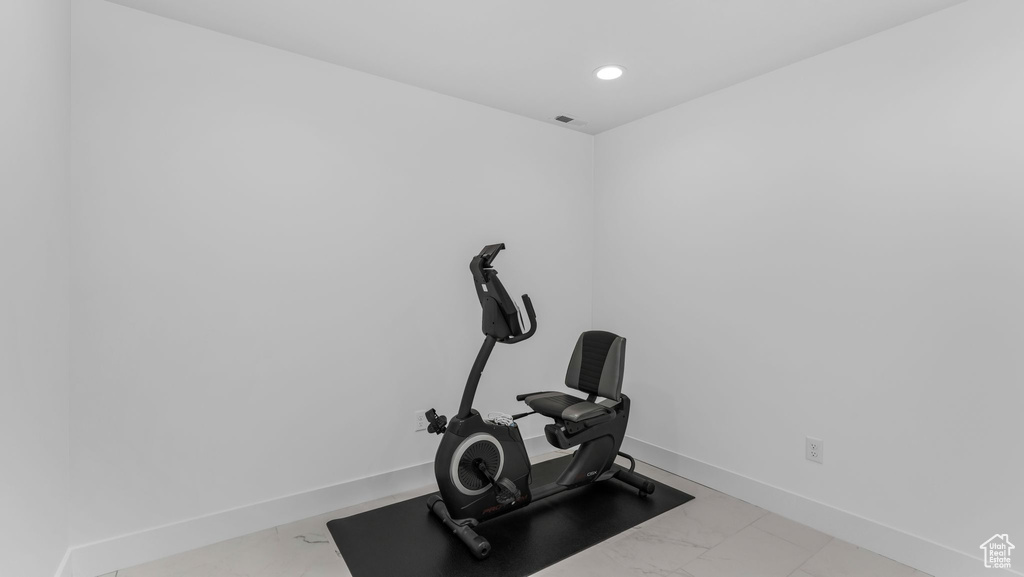 Exercise room with marble finish flooring, baseboards, and recessed lighting