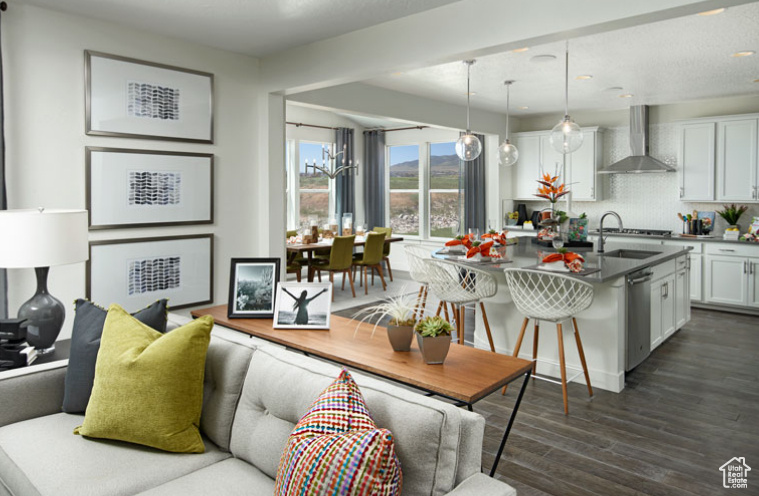 Living room with dark wood-style flooring and recessed lighting