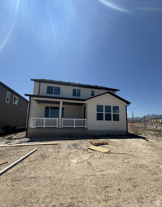 Rear view of property with a porch and a mountain view