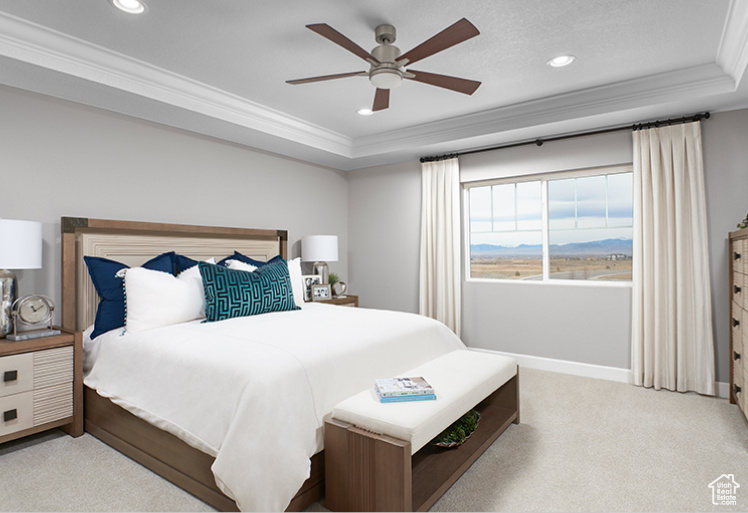 Carpeted bedroom with crown molding, a raised ceiling, recessed lighting, baseboards, and a mountain view