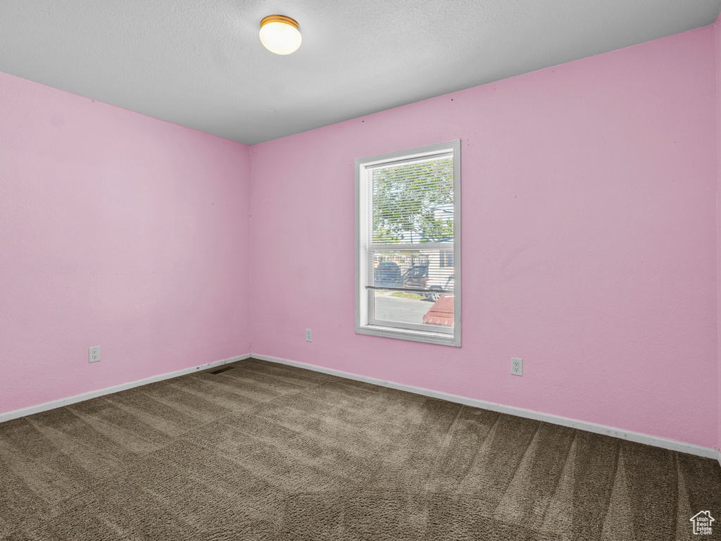 Unfurnished room with carpet floors and baseboards