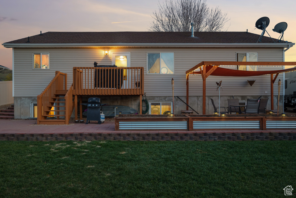 Rear view of property featuring stairs, a patio area, and a yard