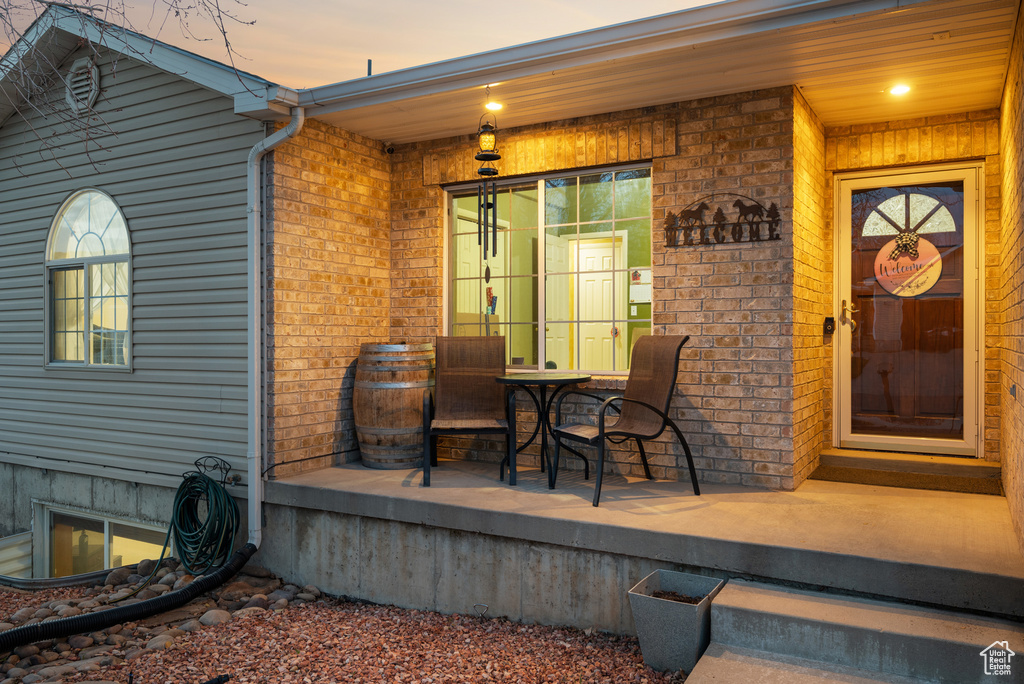 Property entrance featuring brick siding