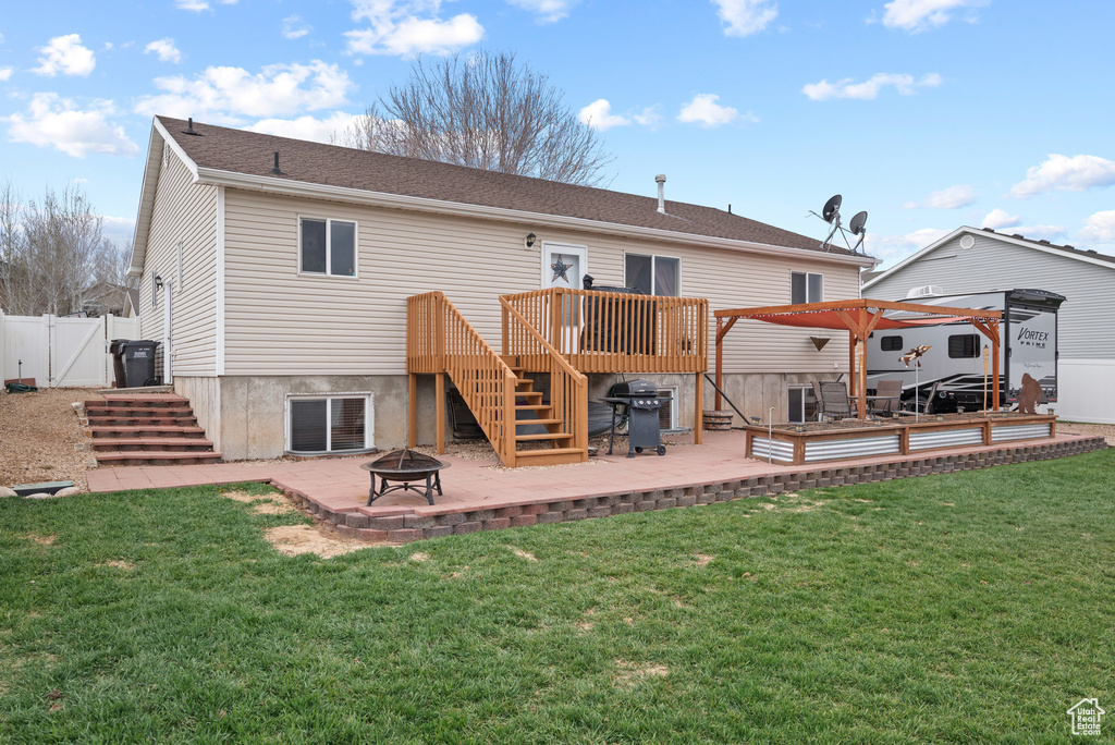 Rear view of property with stairway, fence, a fire pit, a wooden deck, and central AC