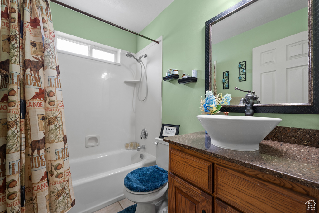 Full bath featuring toilet, vanity, tile patterned floors, and shower / tub combo with curtain