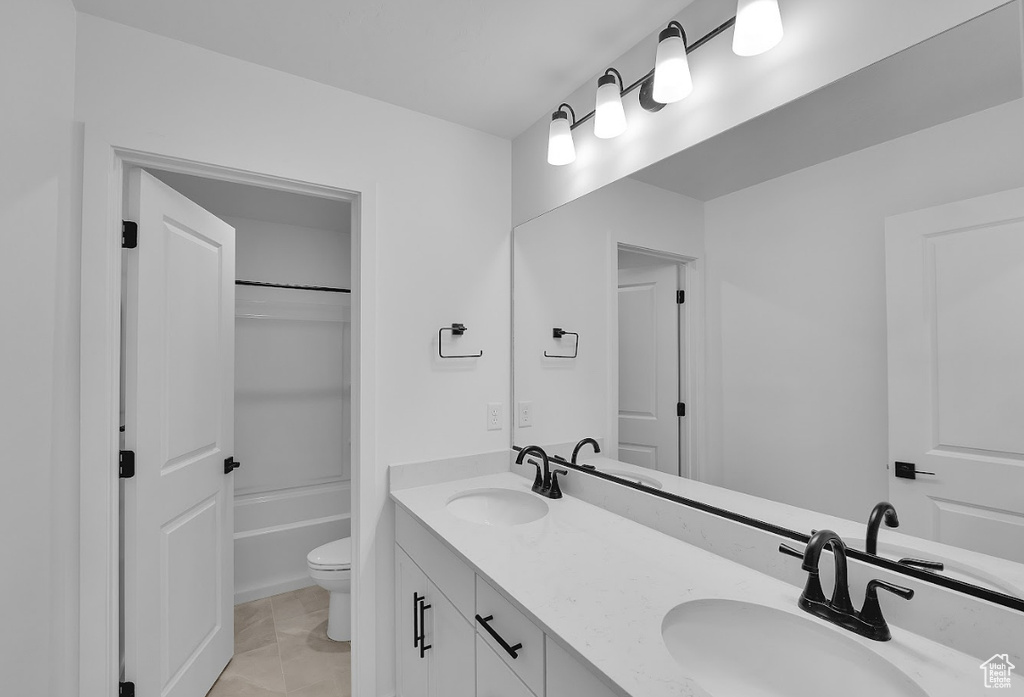Full bathroom with double vanity and bathing tub / shower combination