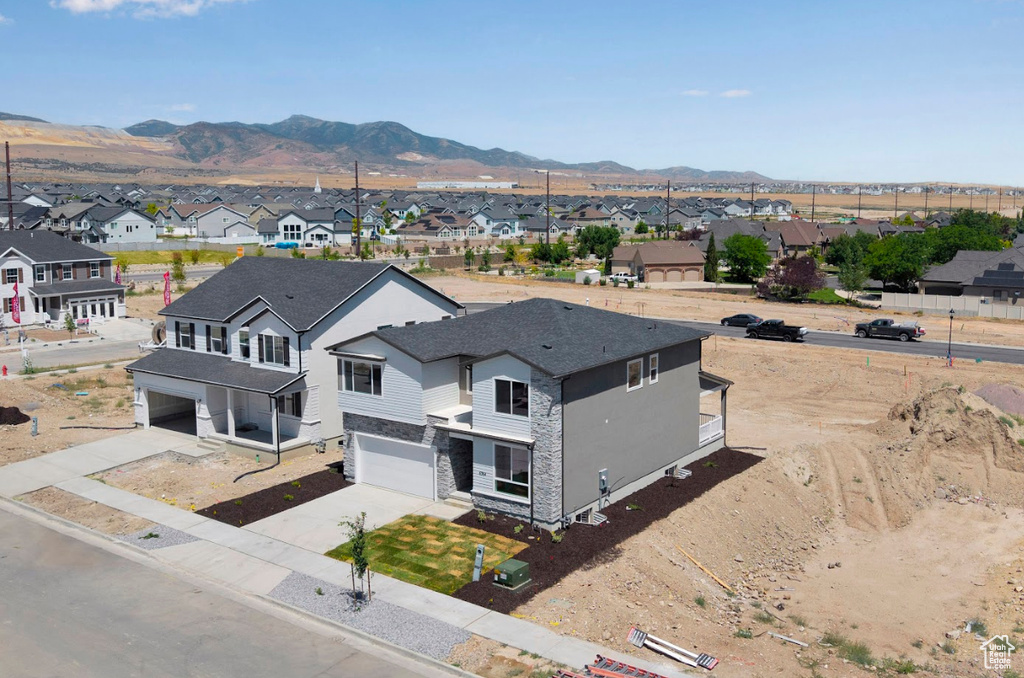 Aerial perspective of suburban area featuring a mountainous background
