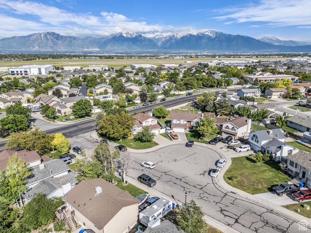 Aerial perspective of suburban area featuring a mountainous background