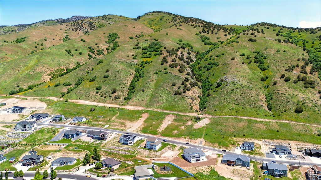 Aerial view of property and surrounding area with nearby suburban area