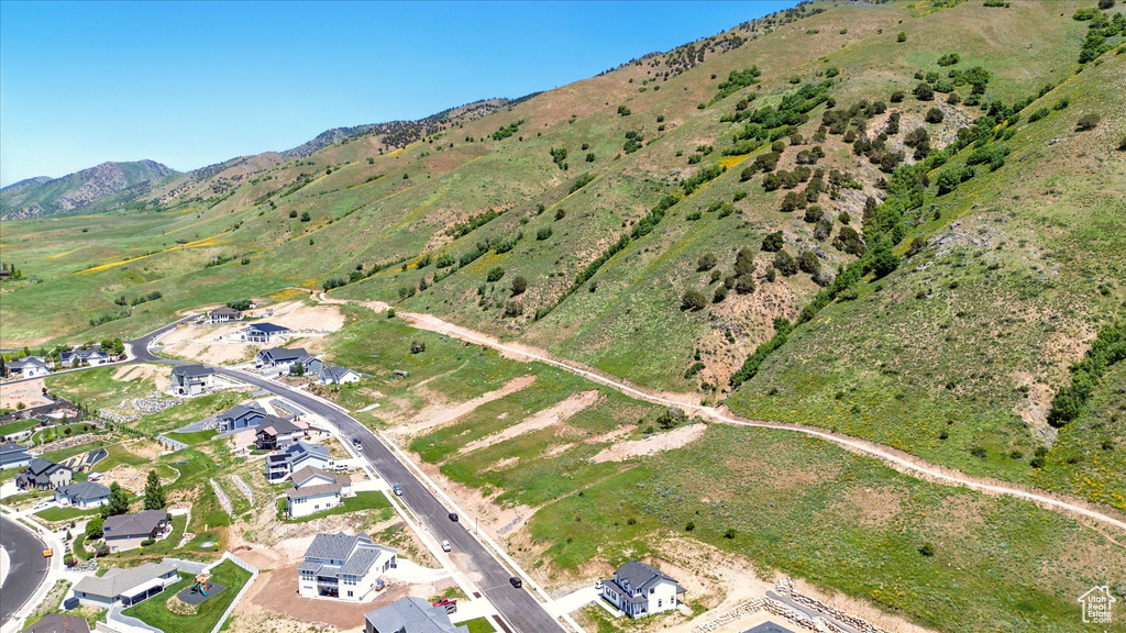 View of property location with mountains and nearby suburban area