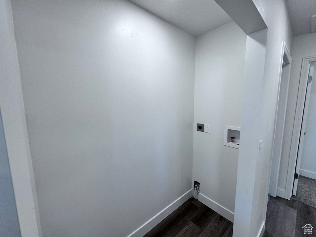 Washroom featuring hookup for an electric dryer, dark wood finished floors, washer hookup, and baseboards
