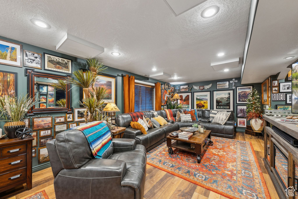 Living room with a textured ceiling and wood finished floors