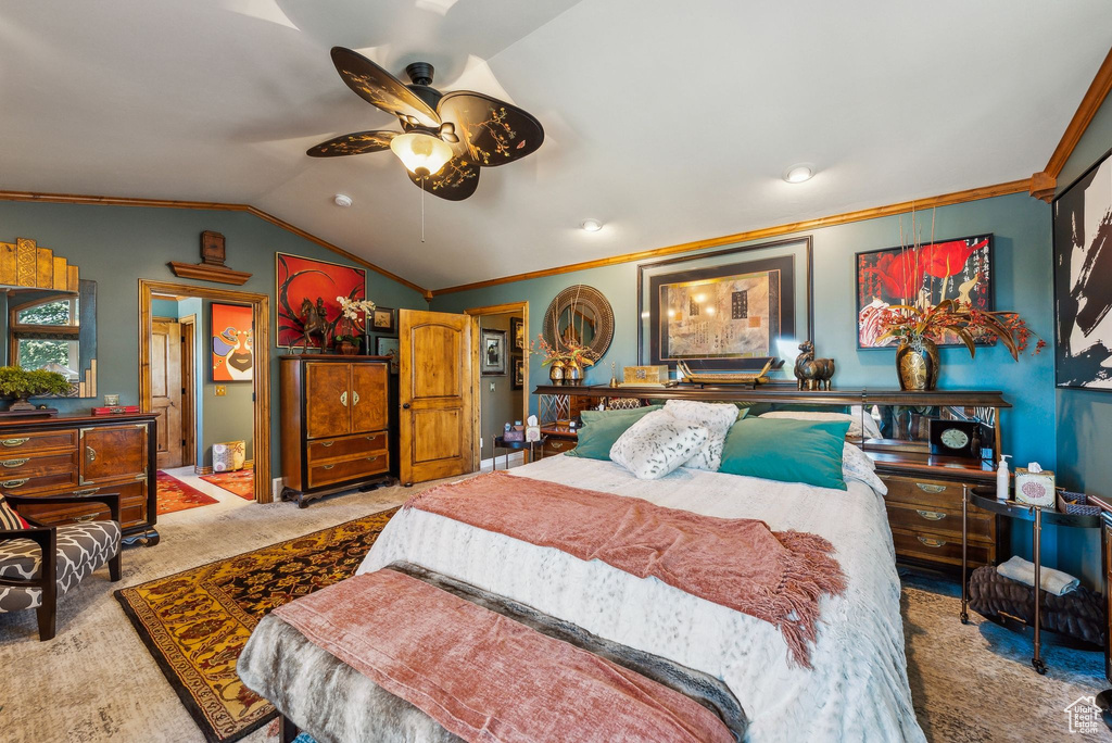 Carpeted bedroom featuring ornamental molding and lofted ceiling