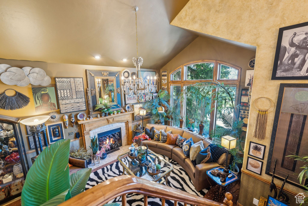 Living area with a chandelier, a tiled fireplace, and recessed lighting