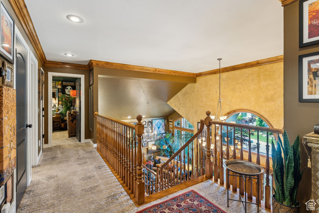 Stairs featuring crown molding, a chandelier, baseboards, and recessed lighting