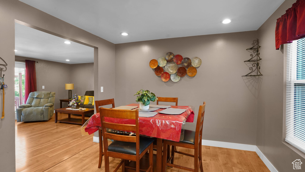 Dining room with light wood-style floors, recessed lighting, and baseboards