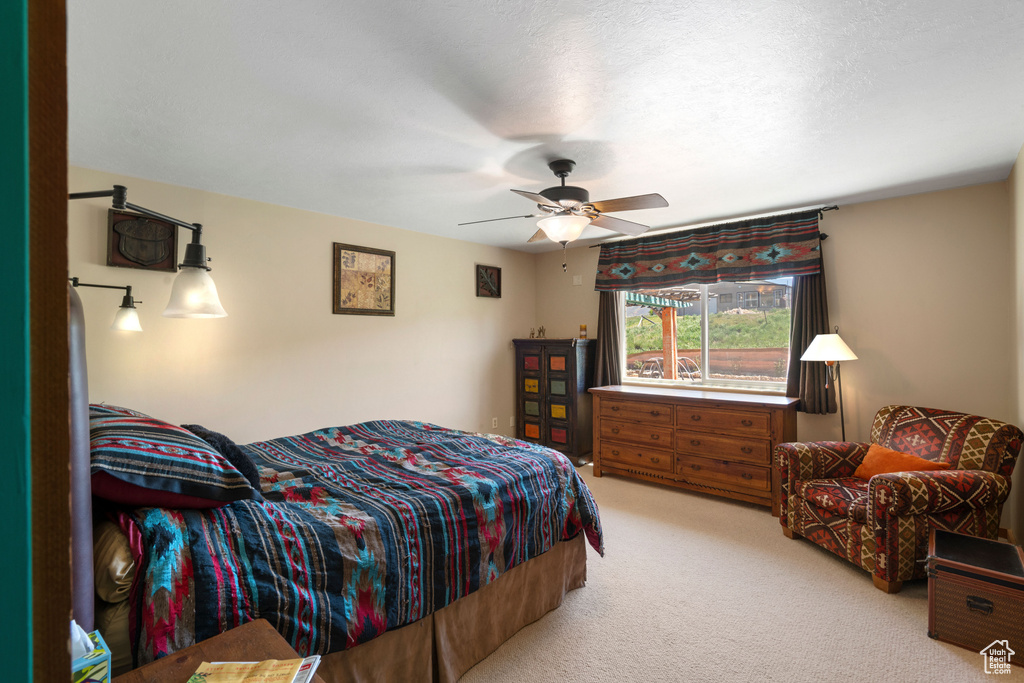 Bedroom featuring light colored carpet and ceiling fan