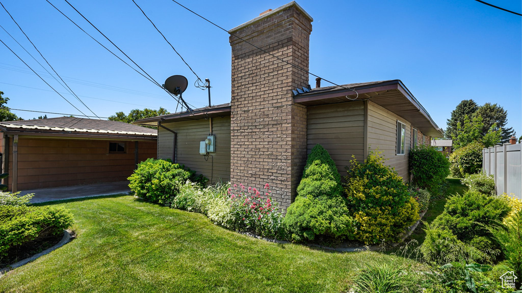 View of property exterior with a chimney