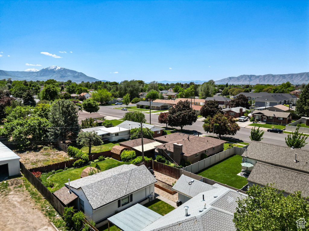 Aerial perspective of suburban area featuring a mountainous background