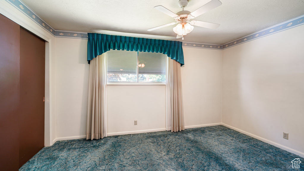Unfurnished bedroom featuring carpet, ceiling fan, and baseboards
