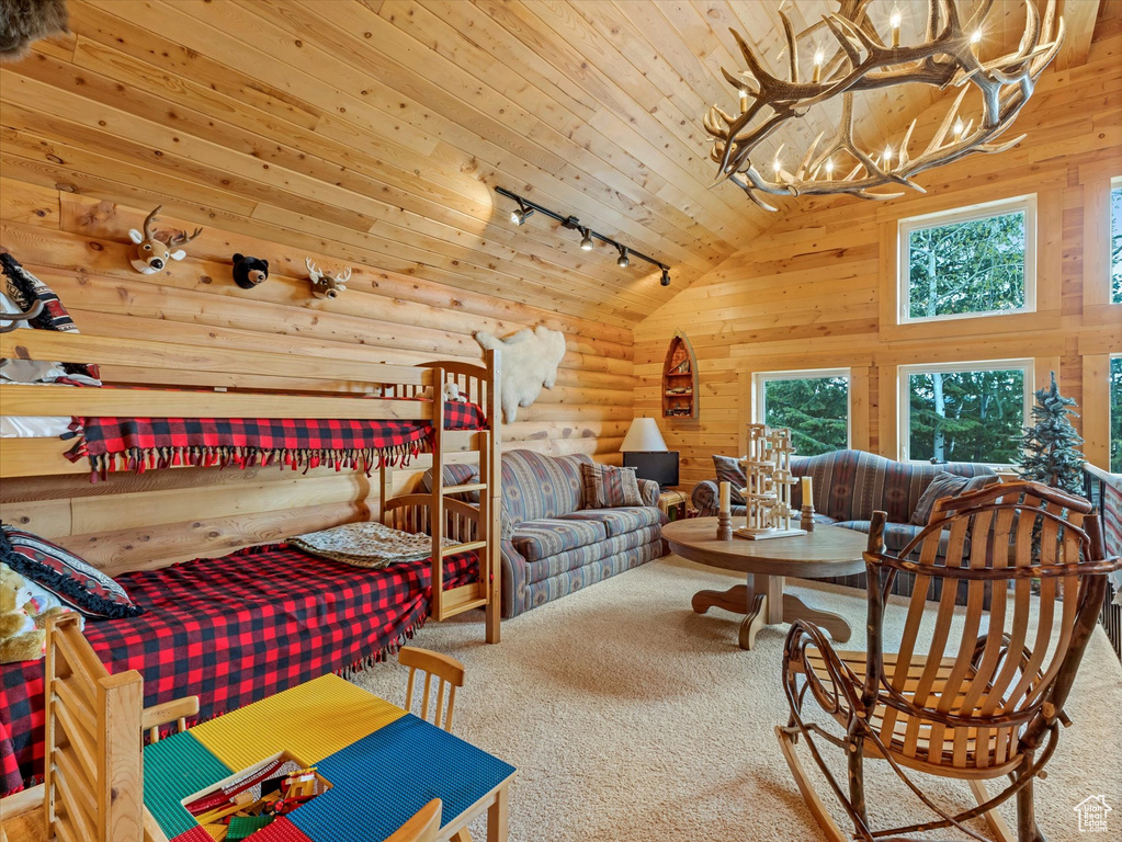 Bedroom with carpet flooring, rail lighting, lofted ceiling, a chandelier, and wood ceiling
