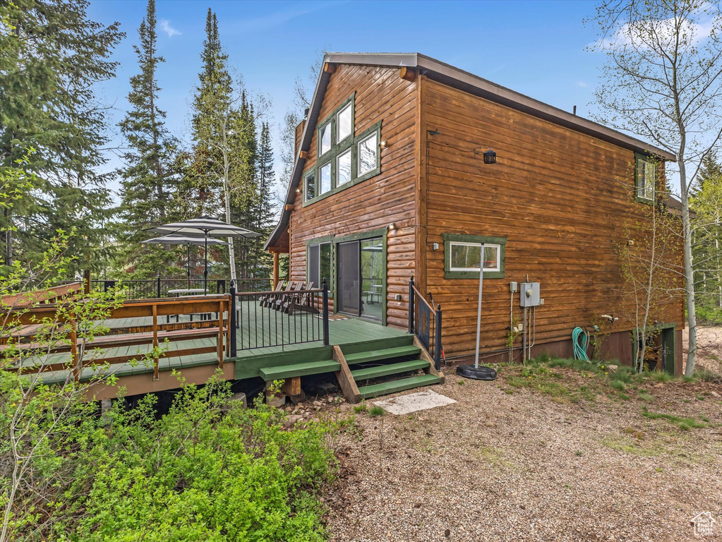 View of home's exterior with a wooden deck