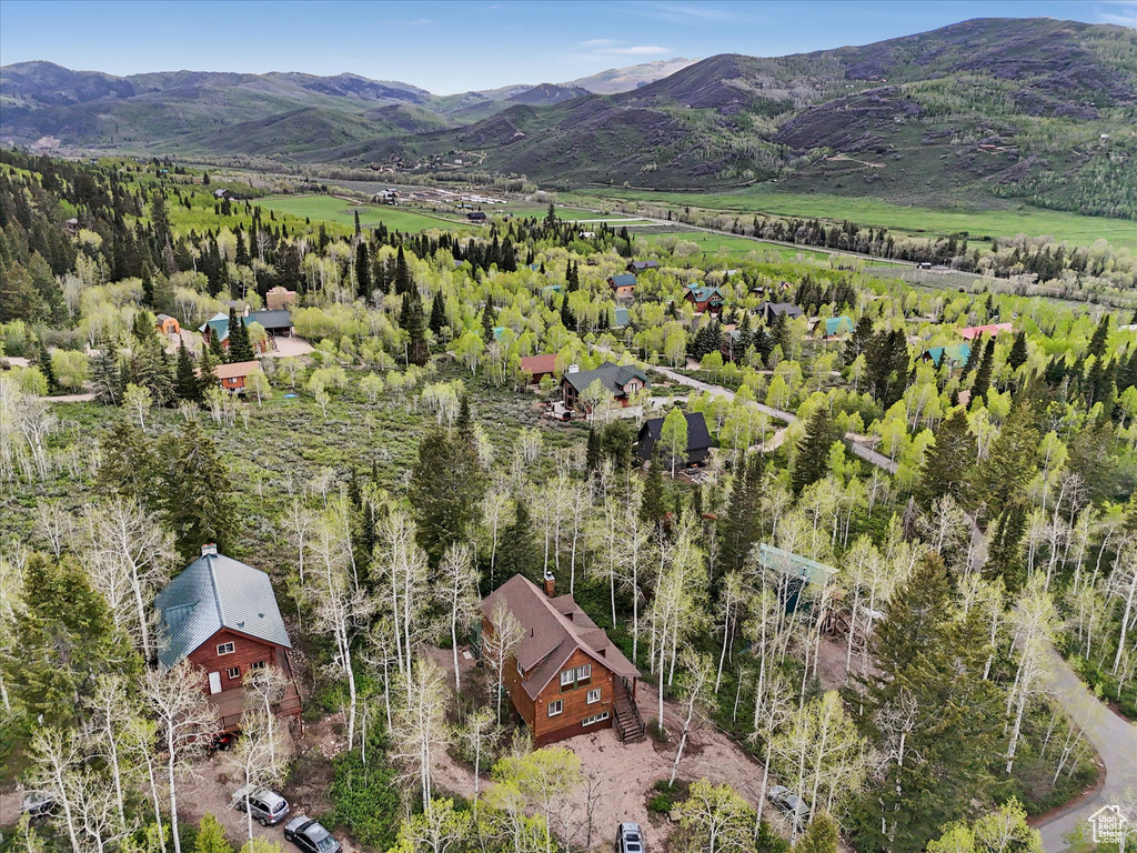 Aerial view of property and surrounding area featuring mountains