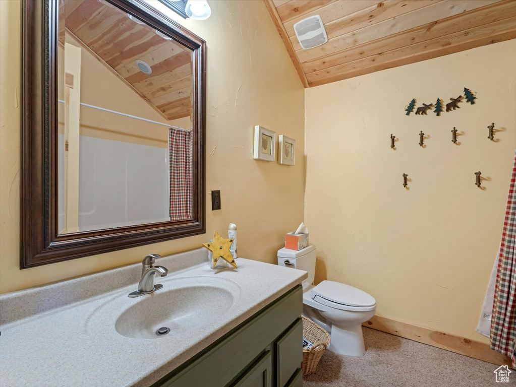 Full bath with lofted ceiling, wooden ceiling, toilet, and vanity